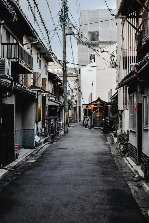 a narrow alley with a clock tower in the background, by Katsukawa Shun'ei, unsplash contest winner, mingei, deserted shinjuku junk town, late afternoon, old asian village, ethnicity : japanese