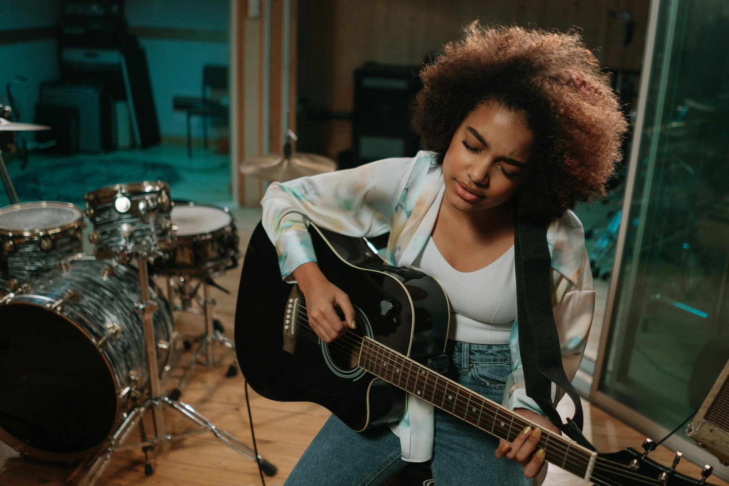 a woman playing a guitar in a recording studio, trending on pexels, photorealism, nathalie emmanuel, promotional images, sza, schools