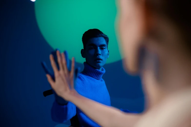 a man standing in front of a mirror holding a green balloon, trending on pexels, fantastic realism, blue turtleneck, projection mapping, photo of a hand jewellery model, blue skin