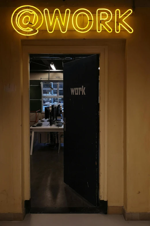 a neon sign hanging from the side of a building, a picture, in a open-space working space, door to lab, wok, imgur