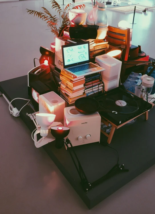 a laptop computer sitting on top of a pile of books, an album cover, inspired by Elsa Bleda, computer art, turntables, low fi, projection mapping, board games on a table