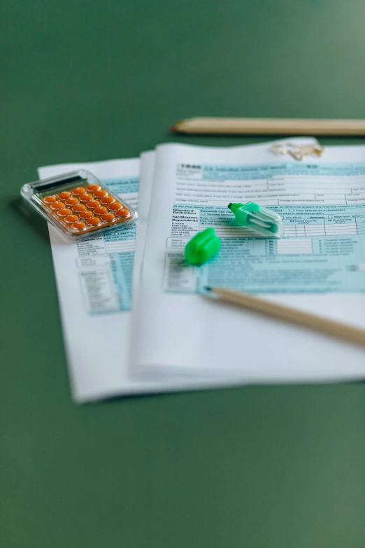 a pair of scissors sitting on top of a piece of paper, on a table, thumbnail, forms, medical supplies