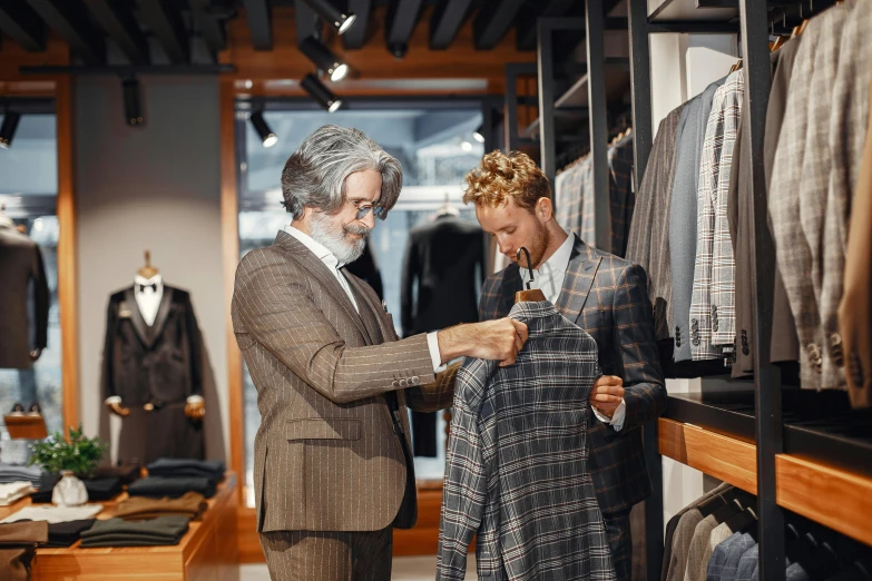 a couple of men standing next to each other in a room, pexels contest winner, people shopping, wearing wool suit, inspect in inventory image, tartan garment