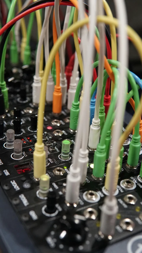 a close up of a bunch of wires on a keyboard, by Jesse Richards, synchromism, modular synth, multi - coloured, dj mixer, photographed for reuters