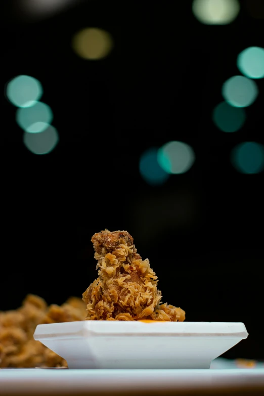 a close up of a plate of food on a table, happening, fried chicken, night sky, f / 1 1 bokeh depth of field, nug pic