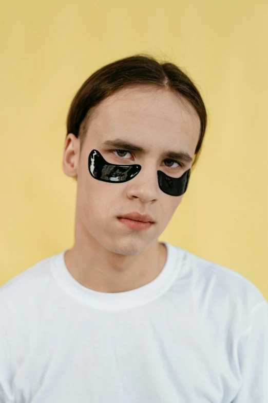 a young man wearing a pair of eye patches, an album cover, inspired by Hedi Xandt, trending on pexels, vitaly bugarov, big forehead, lean man with light tan skin, techno eye