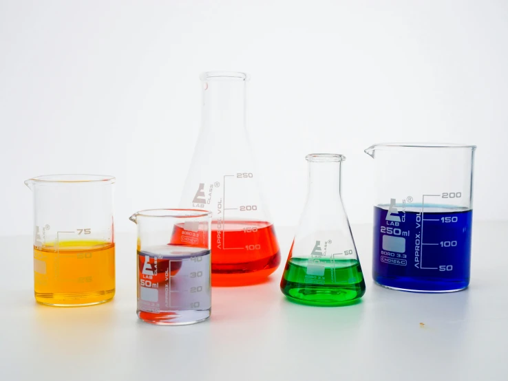 a group of different colored liquids sitting next to each other, beakers, detailed product shot, detailed product image, reverse