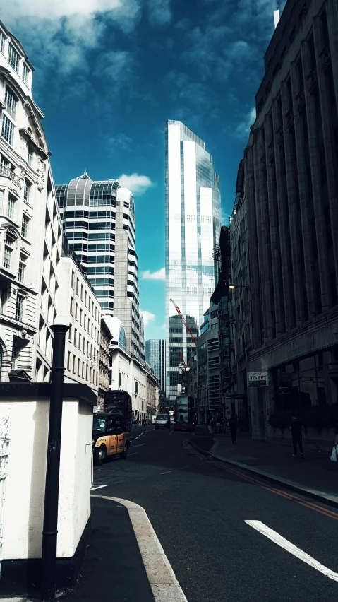 a city street filled with lots of tall buildings, inspired by Richard Wilson, unsplash contest winner, modernism, england, low quality photo, square, norman foster