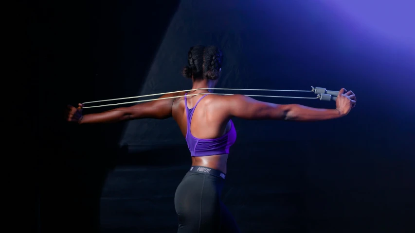 a woman in a purple sports bra top and black leggings, unsplash, process art, hold mechanical bow and arrow, showing her shoulder from back, serena williams, promo image
