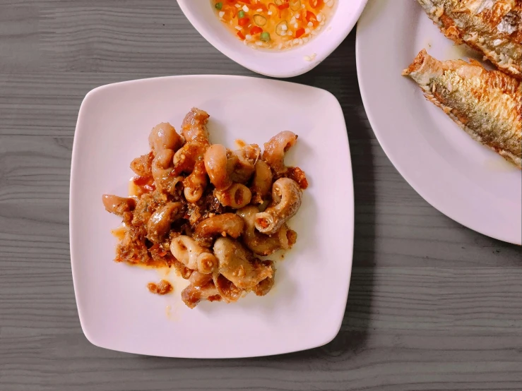 a close up of a plate of food on a table, inspired by Bernardo Daddi, unsplash, dau-al-set, squids, background image, jollibee city, high - angle view