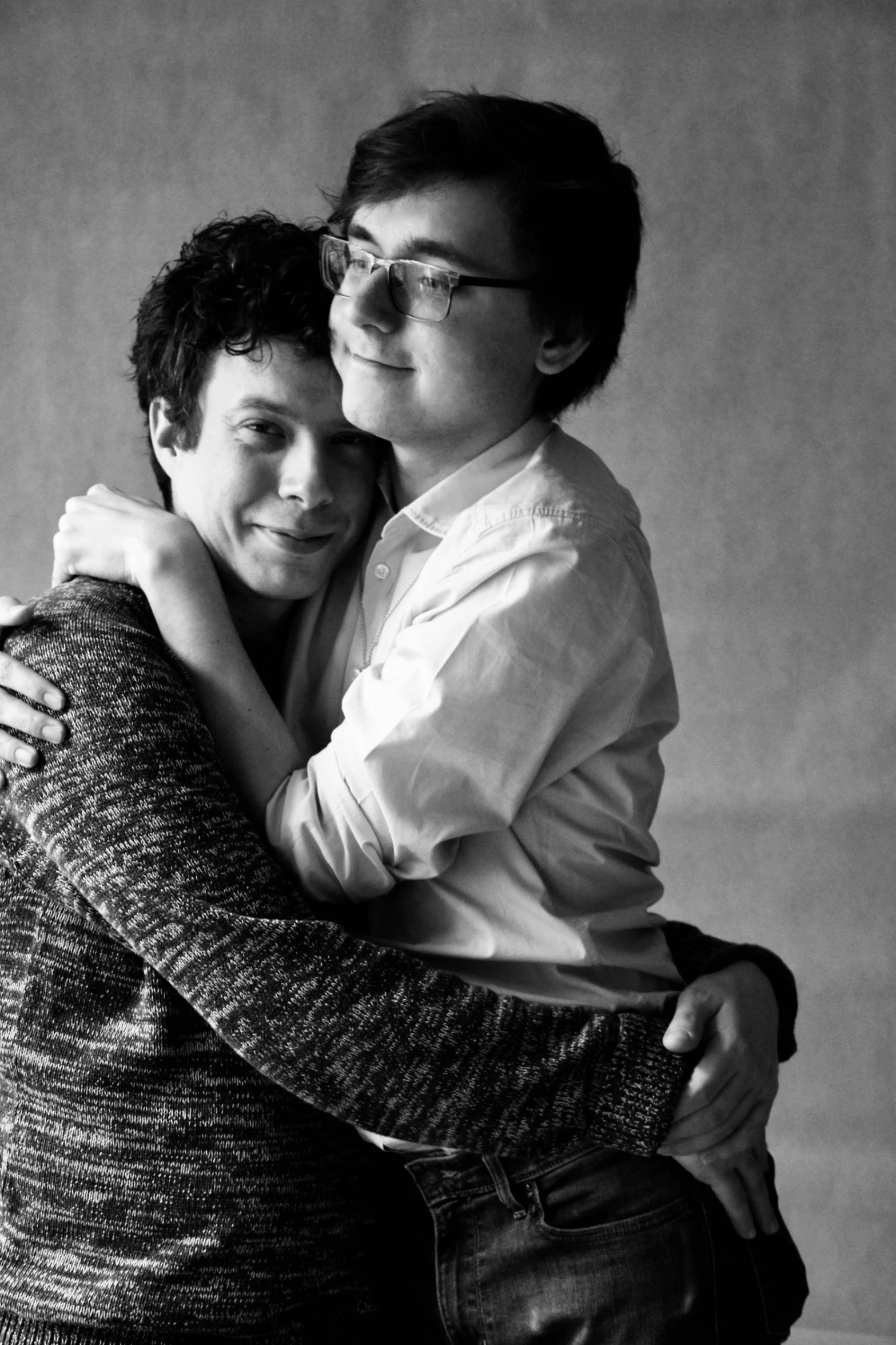 a couple of people that are hugging each other, a black and white photo, by Felix-Kelly, ben folds portrait, finn wolfhard, ((portrait)), sergey krasovskiy