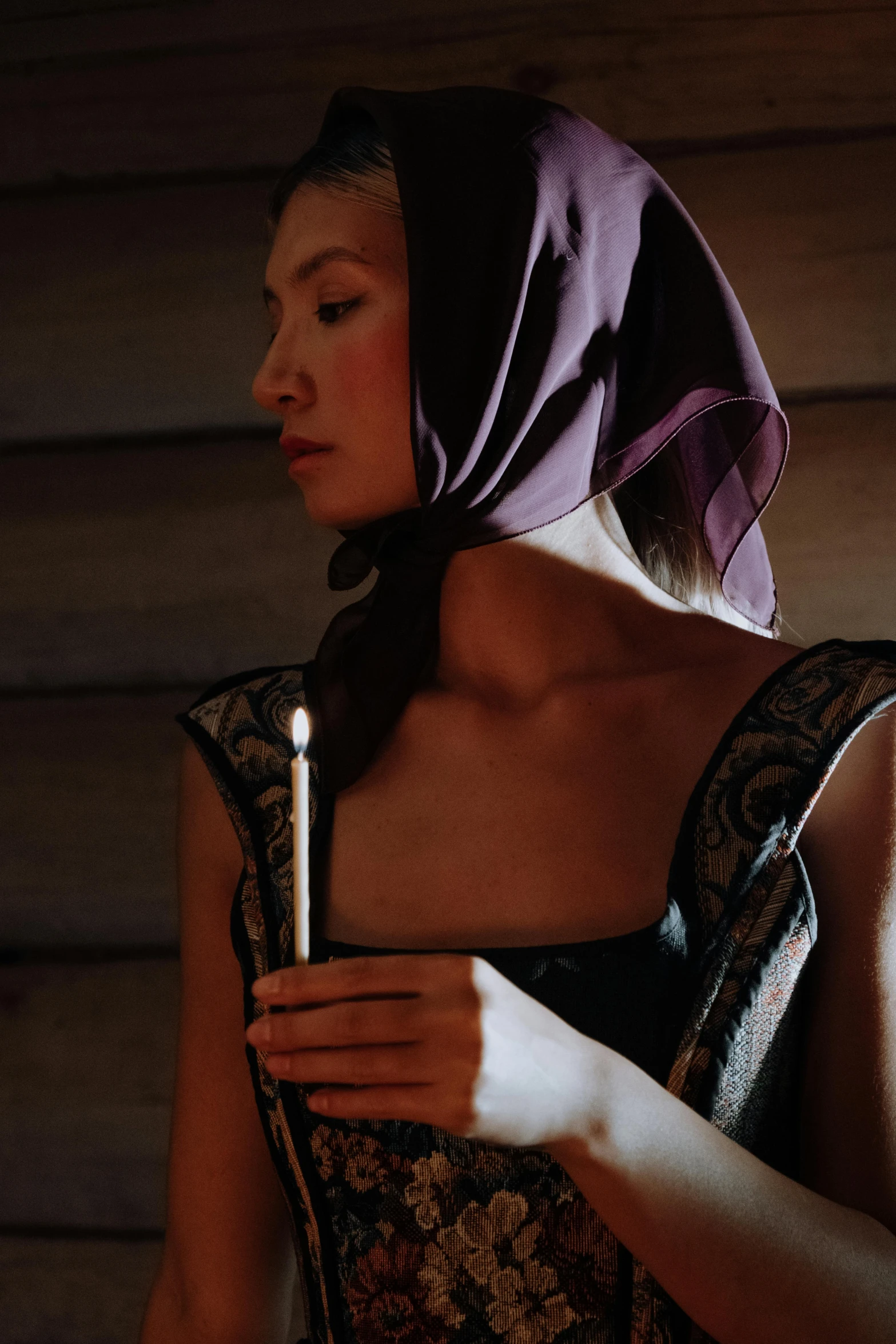 a woman in a dress holding a candle, inspired by Georges de La Tour, unsplash, renaissance, wearing a head scarf, kiko mizuhara, purple, film still