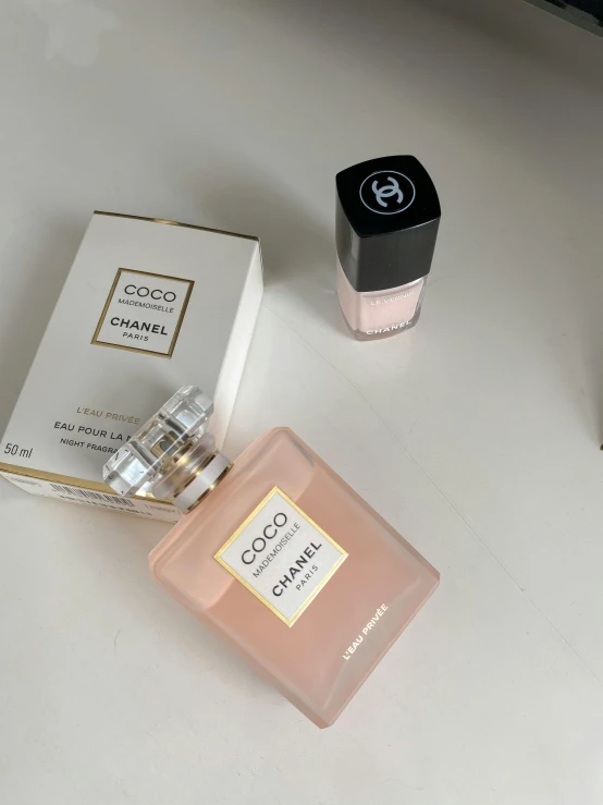 a close up of a bottle of perfume on a table, thumbnail, ((pink)), pale beige sky, unedited