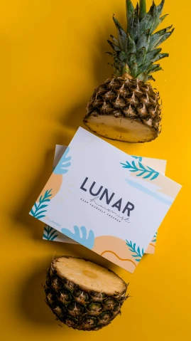 two pineapples sitting next to each other on a yellow surface, an album cover, by Julia Pishtar, unsplash contest winner, sumatraism, moon landing, ui card, lunch time on uranus, behance lemanoosh