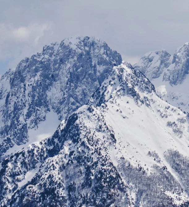 a group of people riding skis on top of a snow covered mountain, today\'s featured photograph 4k, mount olympus, high polygon, seen from a distance