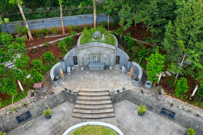 an aerial view of a building surrounded by trees, a statue, hurufiyya, stone pews, coban, concept photo, well decorated