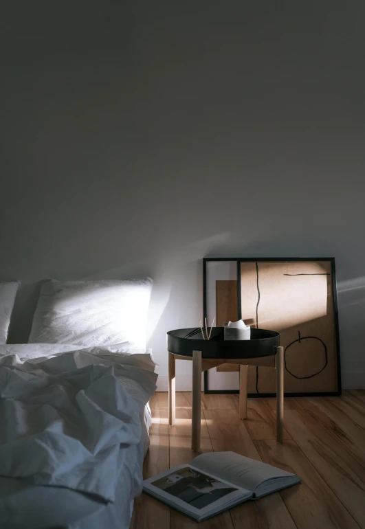 a white bed sitting on top of a wooden floor, inspired by Donald Judd, unsplash contest winner, light and space, shot with hasselblad, wooden side table, soft light.4k, dwell