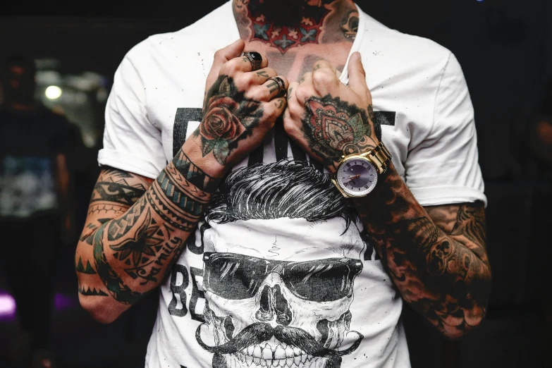 a man with tattoos on his arms and chest, trending on pexels, skulls, dressed in a white t shirt, wearing a watch, hipster