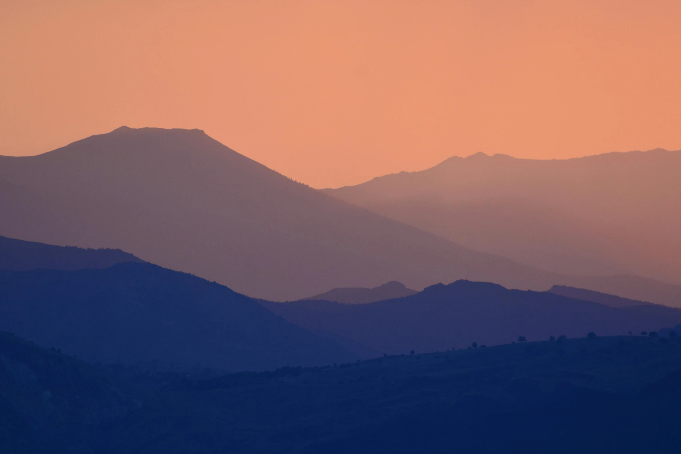 a plane flying over a mountain range at sunset, by Alexis Grimou, pexels contest winner, romanticism, layers of strata, pink, siluettes, marbella landscape