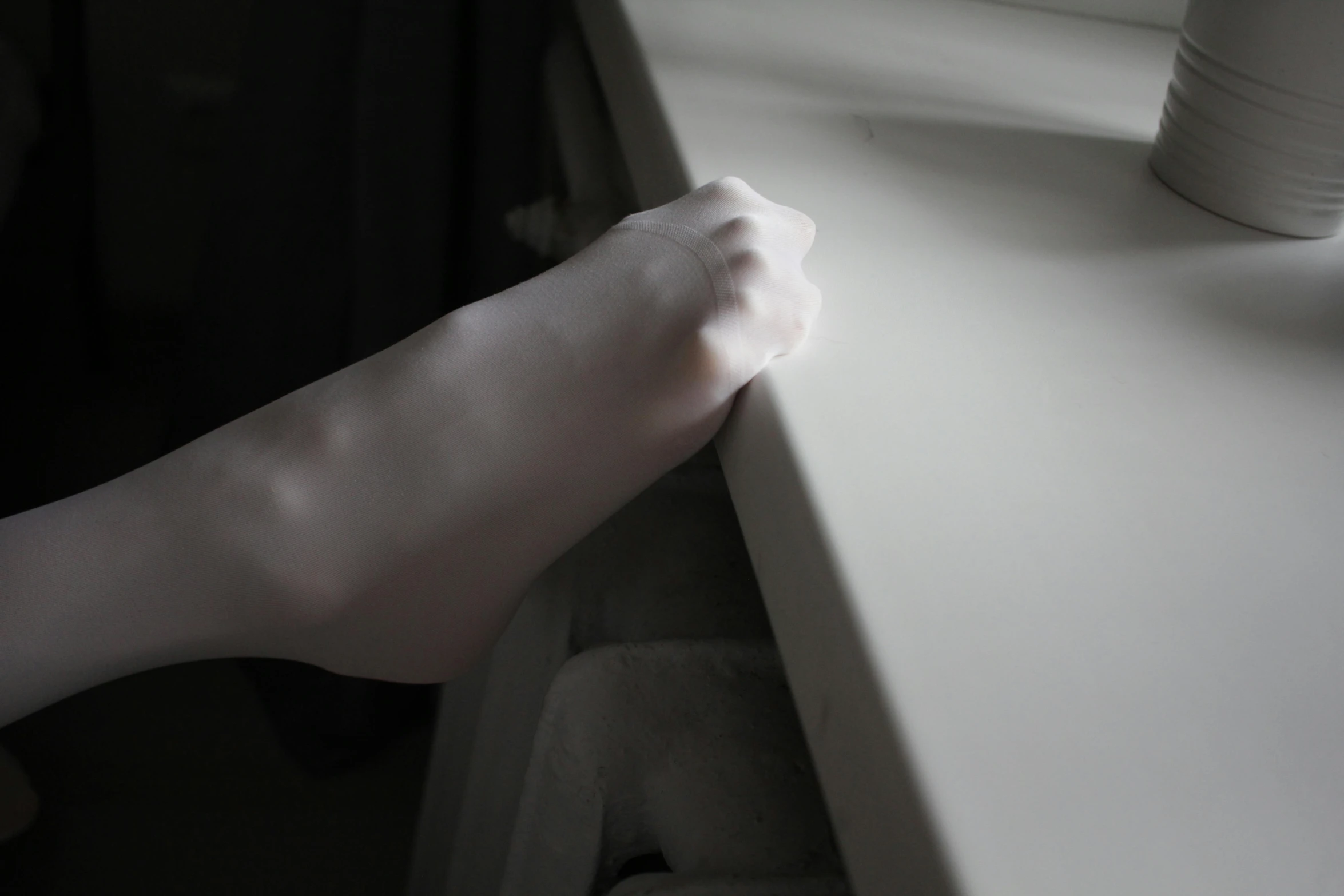 a close up of a person's hand on a window sill, hyperrealism, soft white rubber, exiting from a wardrobe, extremely pale white skin, bending over