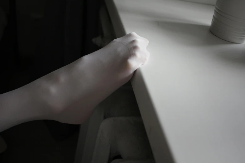 a close up of a person's hand on a window sill, hyperrealism, soft white rubber, exiting from a wardrobe, extremely pale white skin, bending over