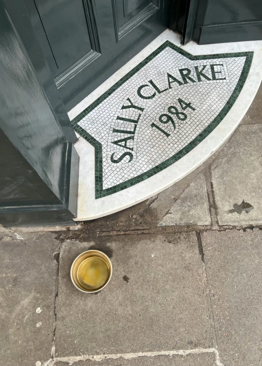 a yellow cup sitting on the ground in front of a door, by Claire Dalby, instagram contest winner, street art, sunken square, sally, ian callum, made of glazed