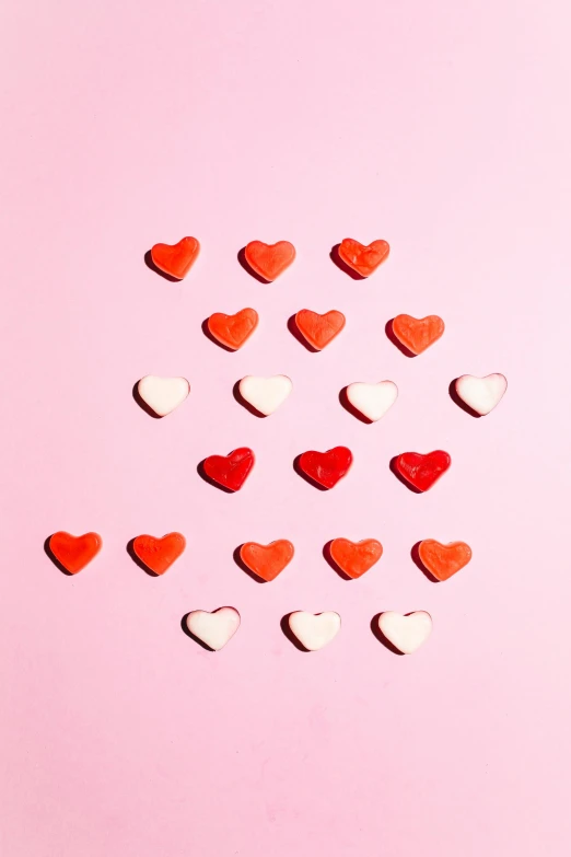 a bunch of red and white hearts on a pink background, by Julia Pishtar, trending on pexels, made of candy, 0, single, girls