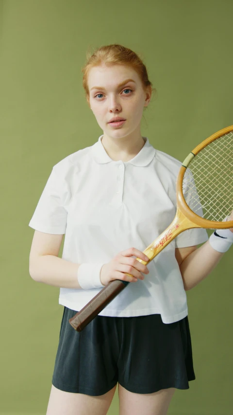 a woman in a white shirt and black shorts holding a tennis racket, an album cover, unsplash, wearing school uniform, ap news photograph, eleanor tomlinson, wearing polo shirt