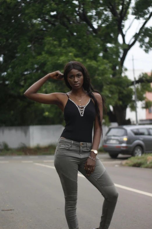 a woman standing on a skateboard on a city street, an album cover, by Chinwe Chukwuogo-Roy, pexels contest winner, renaissance, wearing black camisole outfit, impeccable military composure, wearing v - neck top, muscles