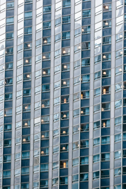 a very tall building with lots of windows, inspired by Andreas Gursky, pexels contest winner, hotel room, light blues, people at work, panels