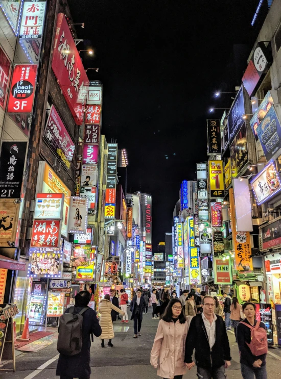 a group of people walking down a street at night, a photo, pexels contest winner, ukiyo-e, lots of signs and shops, square, high resolution photo, bright neon signs