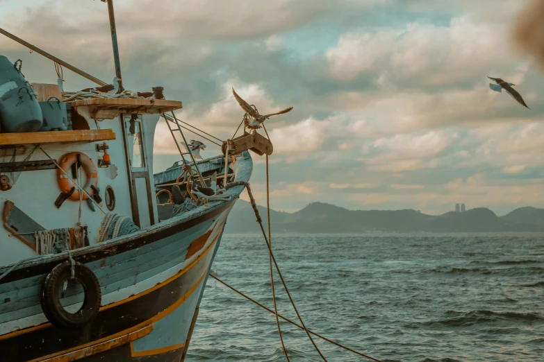 a large boat sitting on top of a body of water, pexels contest winner, fishing village, profile pic, thumbnail, stacked image