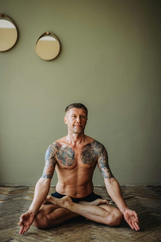 a man sitting in the middle of a yoga pose, a portrait, by Neysa McMein, unsplash, tattooed, oleg korolev, high symmetry, 4 5 yo