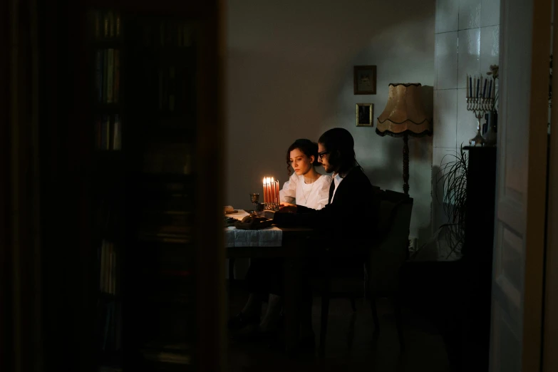 a couple of people that are sitting at a table, by Elsa Bleda, pexels contest winner, australian tonalism, cozy candlelight, reading, lesbians, medium format. soft light