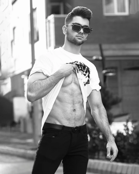 a shirtless man riding a skateboard down a street, a black and white photo, by Robbie Trevino, crop shirt and strong abs, proud smirk, lgbtq, profile pic