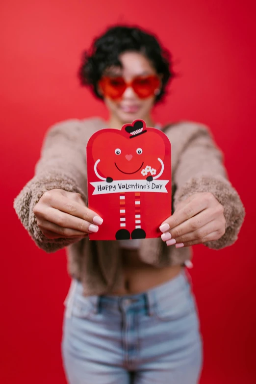 a woman holding a red heart shaped box, an album cover, by Julia Pishtar, pexels contest winner, m & m mascot, card, head to waist, product introduction photo