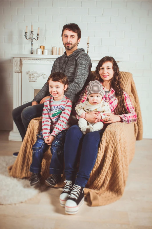 a family sitting on a couch in a living room, a portrait, by Alexander Fedosav, pexels, ukraine. professional photo, square, sitting on chair, promotional image