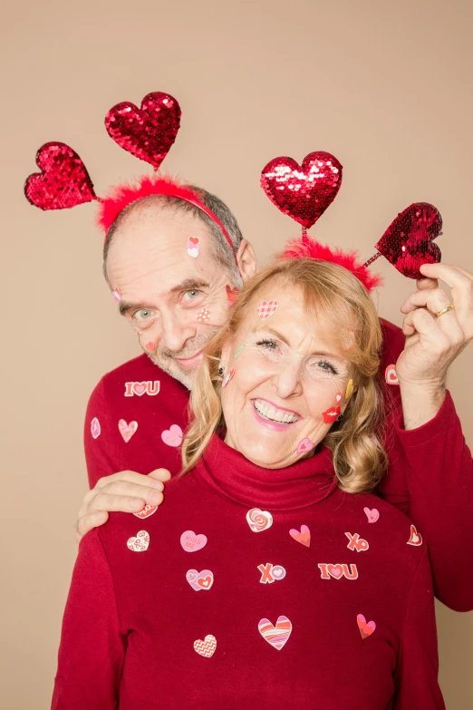 a man and woman posing for a picture with hearts on their heads, antennae, 2 5 6 x 2 5 6 pixels, 5 5 yo, high-quality photo