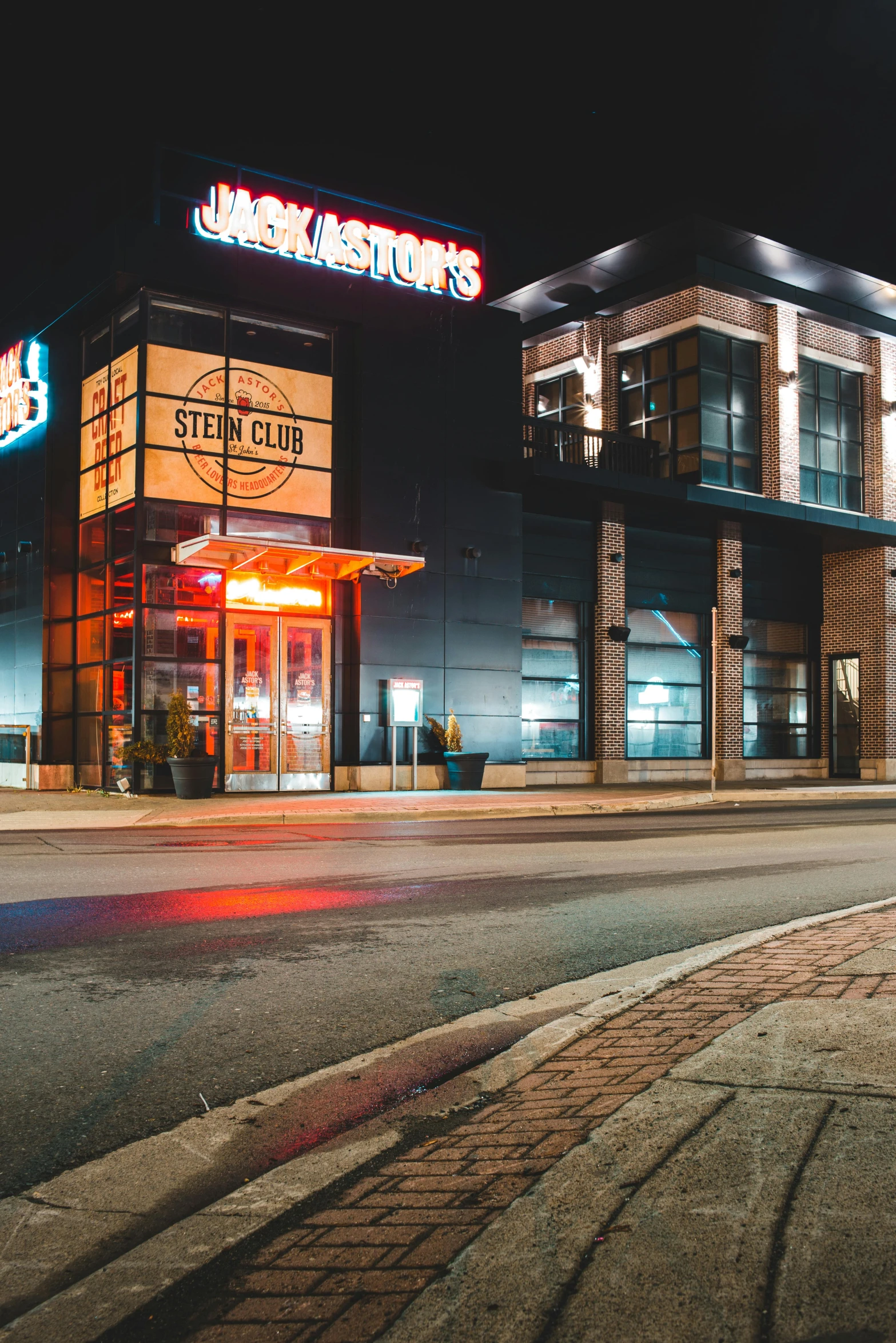 a red fire hydrant sitting on the side of a road, by Andrew Stevovich, sots art, neon lights above shops, club, pistons, panoramic shot