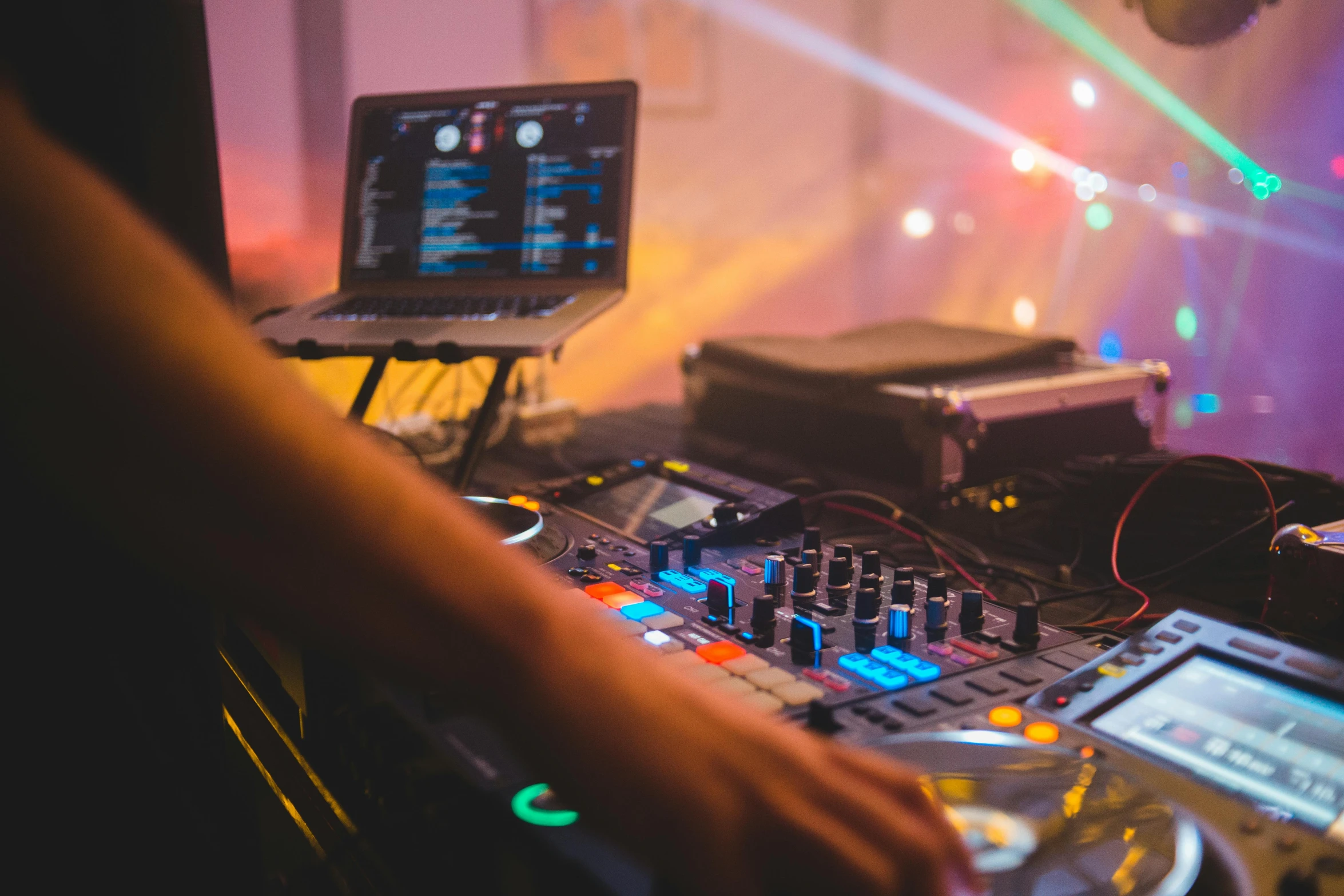 a dj mixing music in front of a laptop, by Julia Pishtar, pexels, party lights, multiple stories, stems, middle shot