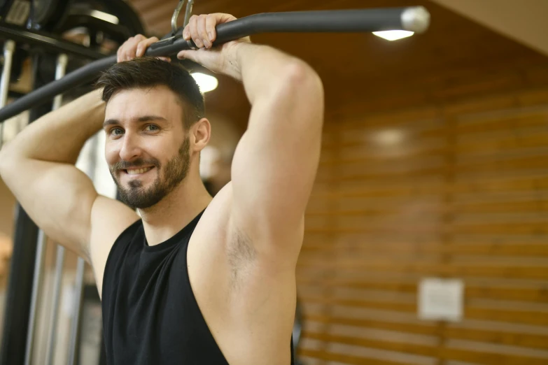 a man using a pull up bar in a gym, a portrait, by Julian Allen, pexels contest winner, renaissance, smiling spartan, thumbnail, 30 year old man :: athletic, no - text no - logo