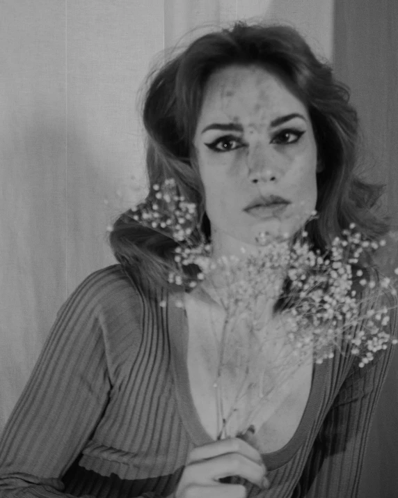 a black and white photo of a woman holding a bunch of flowers, inspired by Kati Horna, sad christina hendricks, seventies cinestill, with a bruised face and bruises, federico pelat