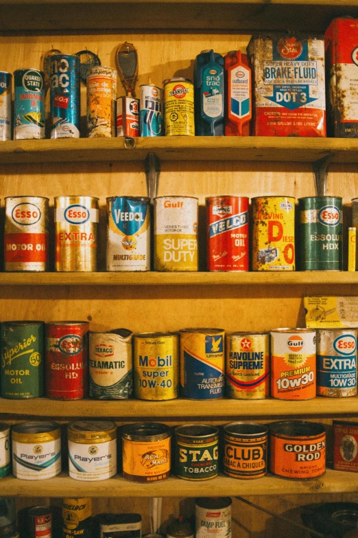 a shelf filled with lots of different types of cans, a portrait, unsplash, 7 0's kitchen, olive oil, battered, garage