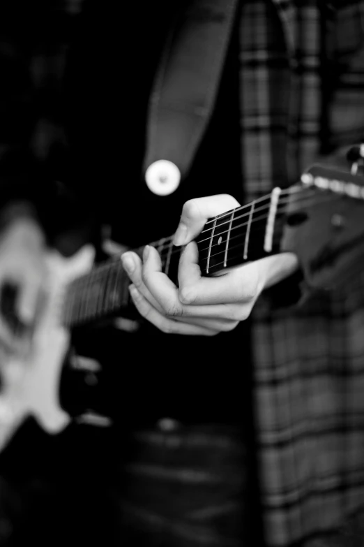 a close up of a person playing a guitar, a black and white photo, by Dave Melvin, unsplash, 15081959 21121991 01012000 4k, digitally enhanced, actual photo, lachlan bailey