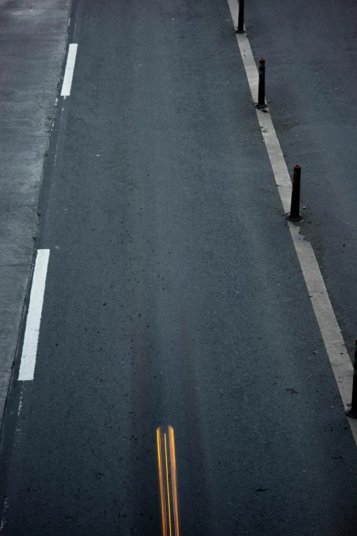 a street filled with lots of traffic next to tall buildings, an album cover, inspired by Andreas Gursky, unsplash, postminimalism, broken road, guardrail, photo pinterest, a single