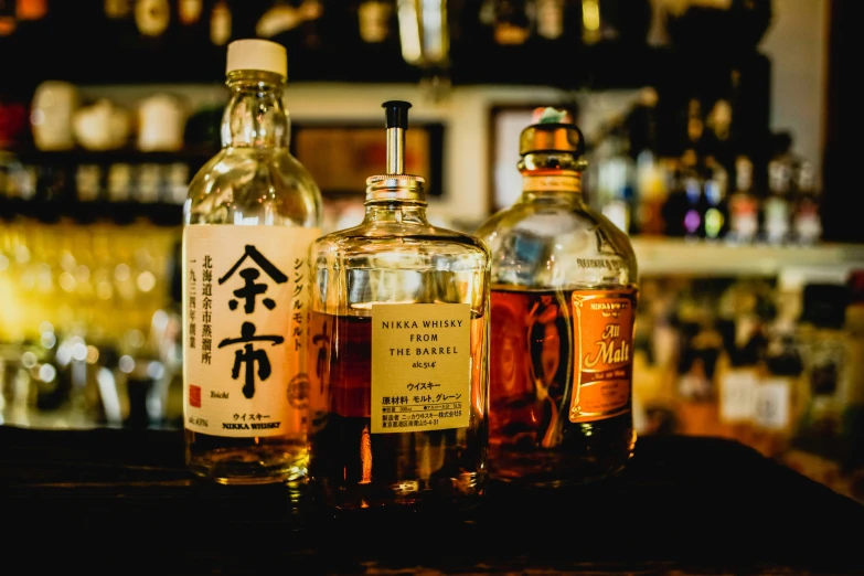 a group of bottles sitting on top of a counter, a portrait, unsplash, sōsaku hanga, rum, daily specials, featured, ukiyo