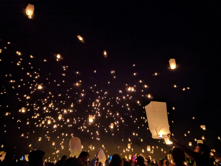 a crowd of people flying paper lanterns at night, pexels contest winner, instagram post, tiny glowbugs everywhere, numerous fires, beautiful day