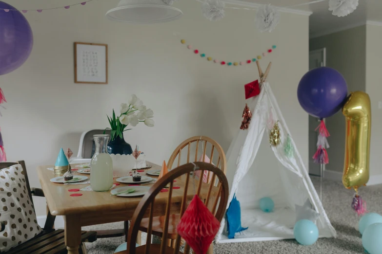 a birthday party with a teepee tent and balloons, pexels contest winner, on kitchen table, cinematic film still, very hazy, decorations