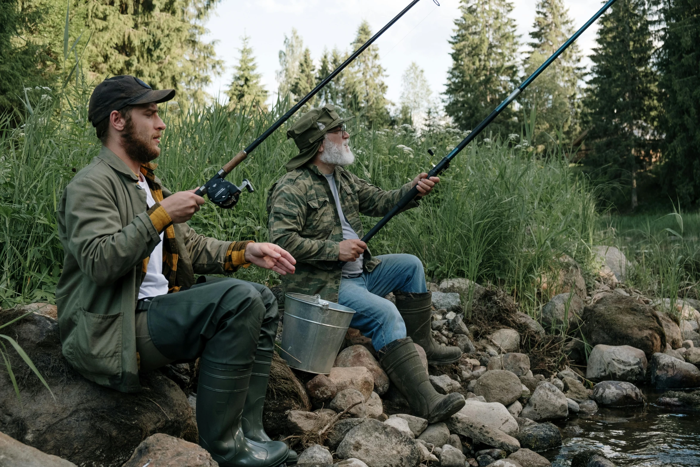 a couple of men sitting on top of a rock next to a river, by Jaakko Mattila, unsplash, renaissance, big bass fishing, overalls and a white beard, game ready, thumbnail