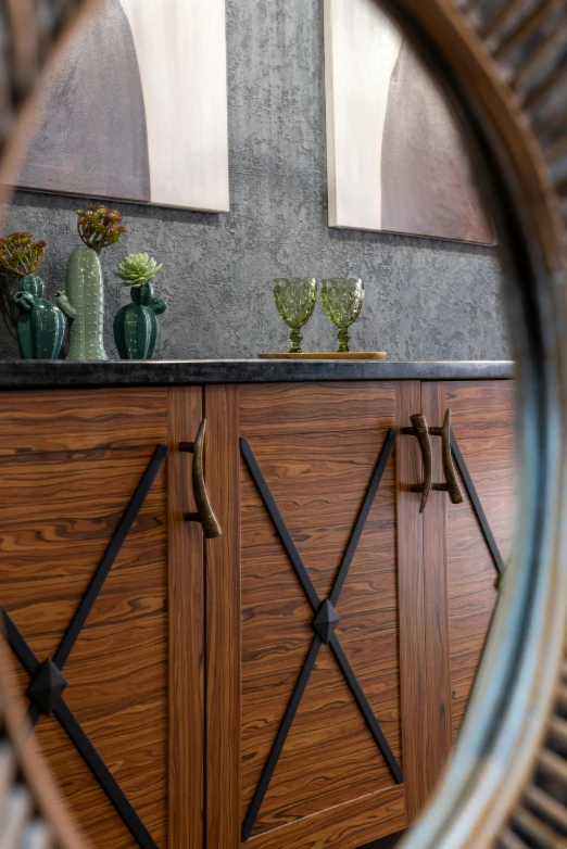 a mirror sitting on top of a wooden cabinet, industrial art style, zoomed in shots, wrought iron, upclose